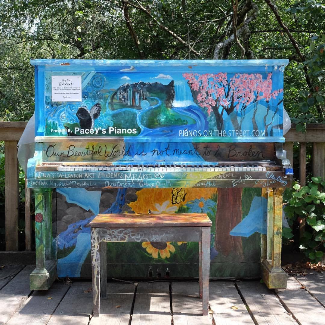 The student-painted piano 'Our Beautiful World is not meant to be Broken', centred on a forest boardwalk.
